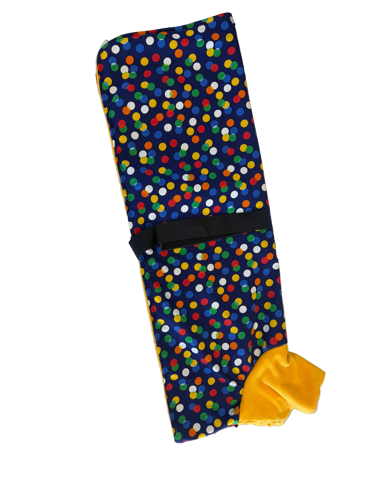 A dog training mat with a colorful polka dot pattern on a navy blue background, featuring a black strap and a yellow plush toy lure, displayed on top of stacked BLACKDOG boxes.